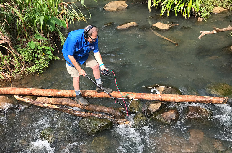 Steven Feld records water sound effects at Wolo Creek, Bona Village, Bosavi, 2018